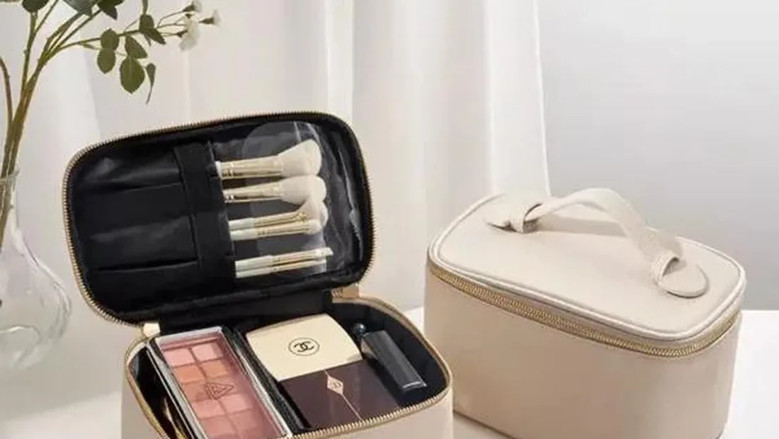 Open lay flat cosmetic bag displaying makeup products